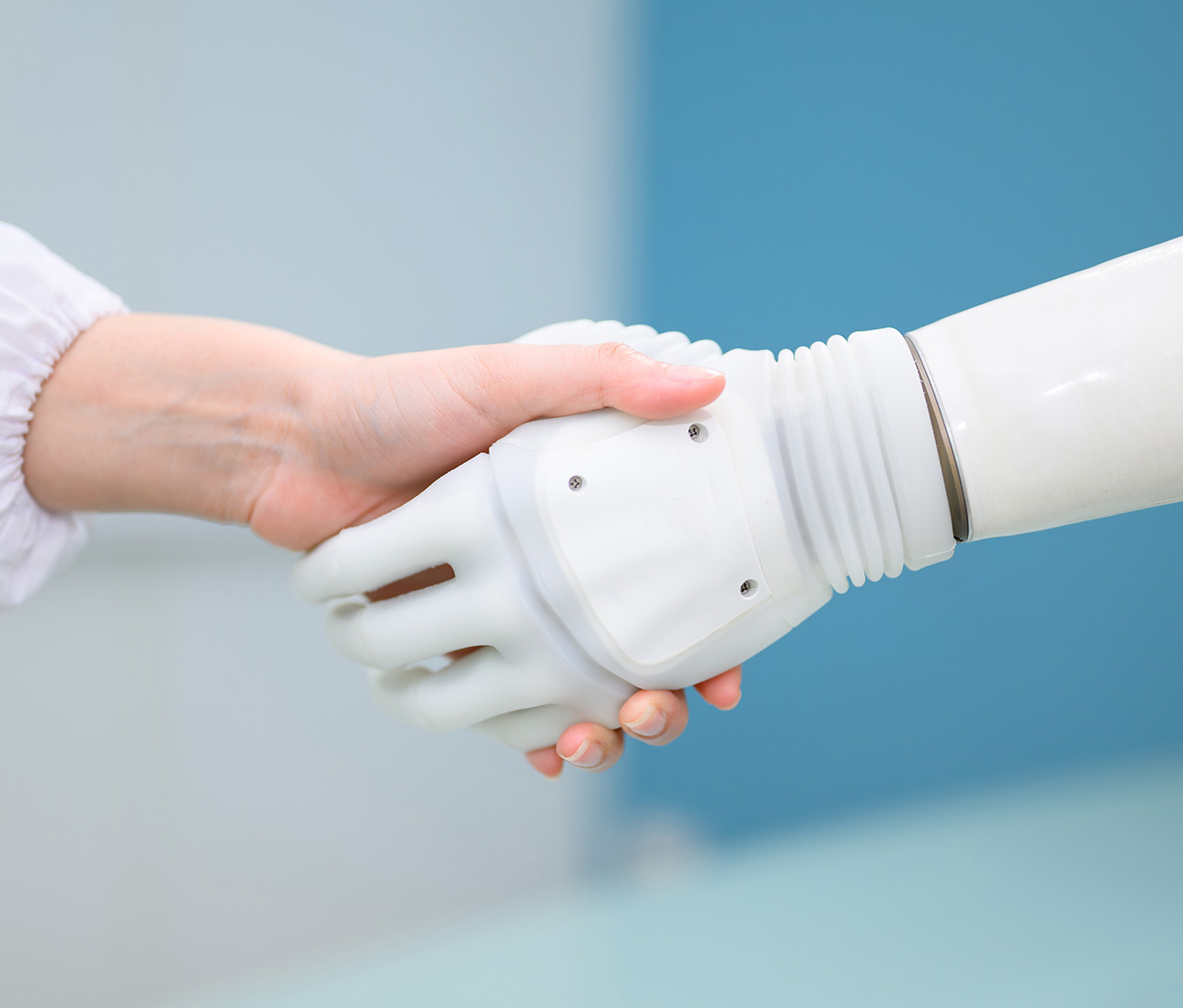 Person shaking hand with a robot